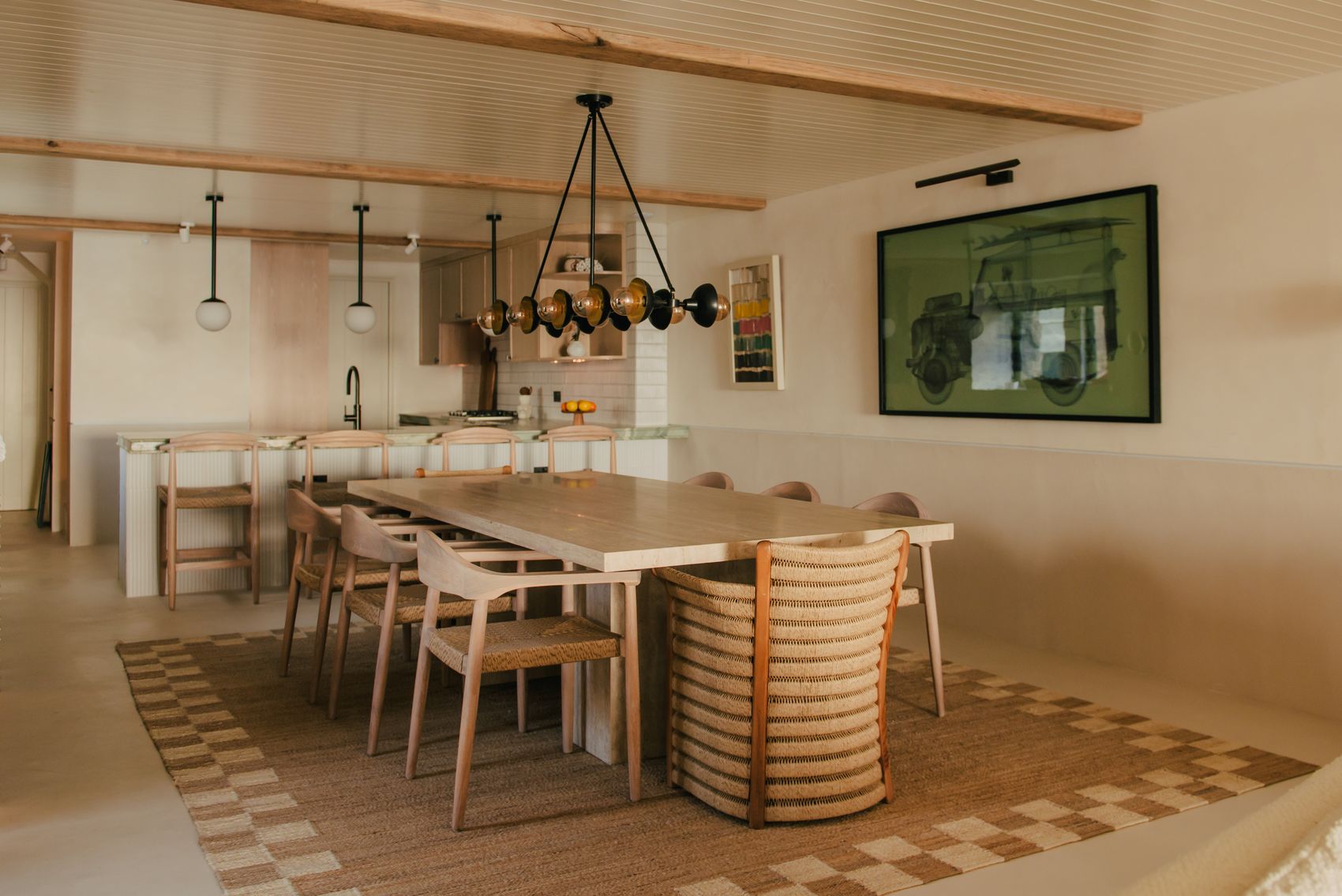 Dining table beneath a wrought pendant