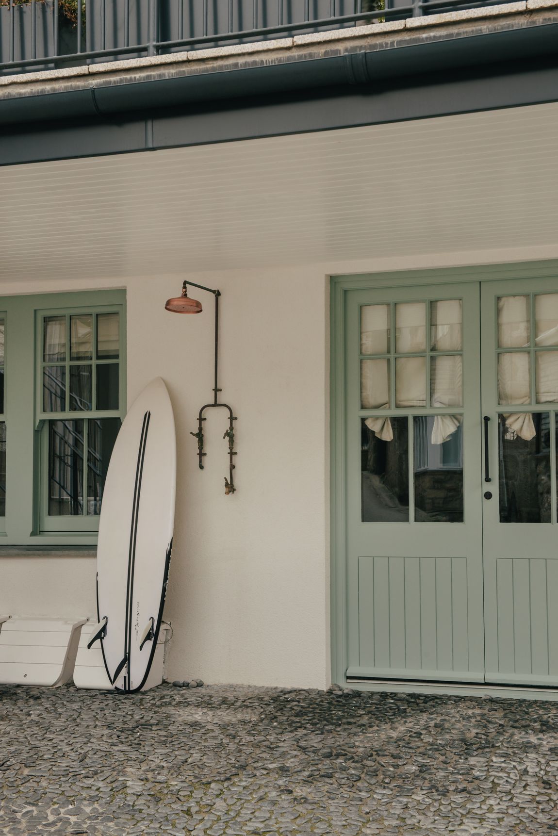 Painted doors and a surfboard by the entrance