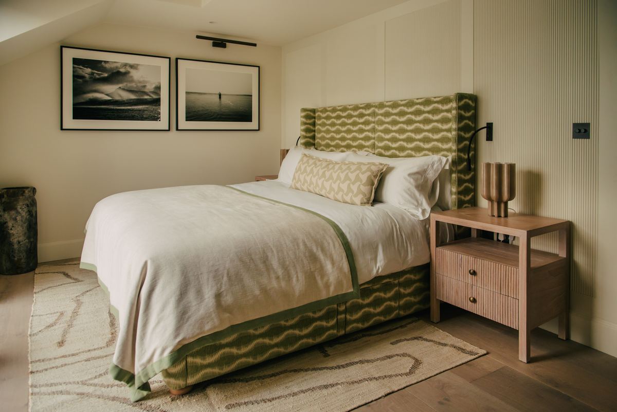 Bedroom with a green upholstered bed