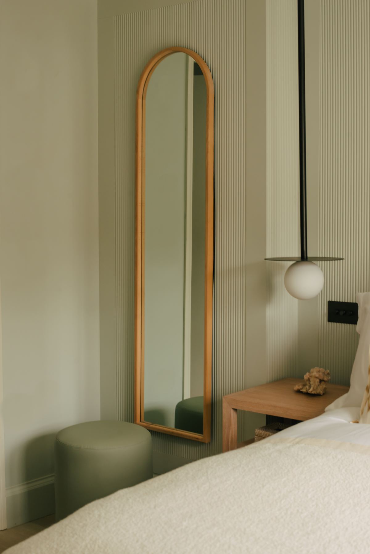 Full-length mirror beside the bed