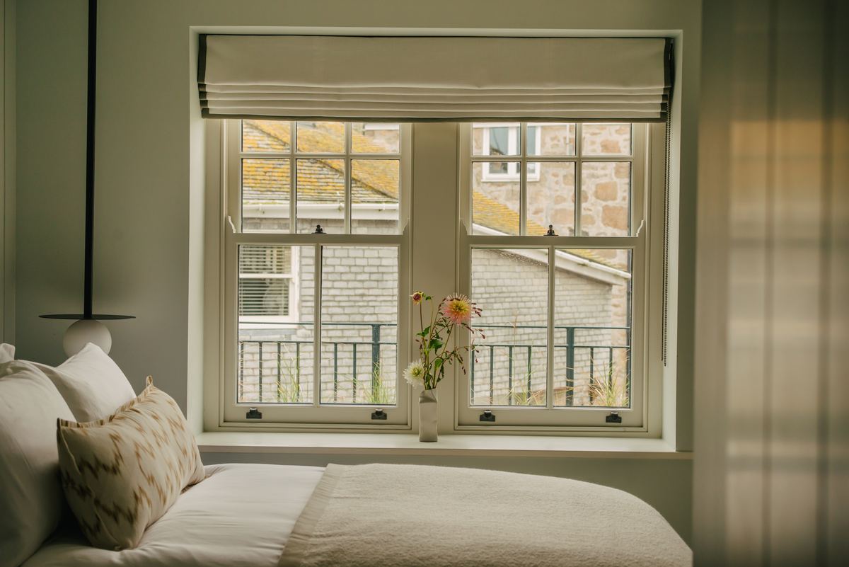 Bedroom with windows over the rooftops