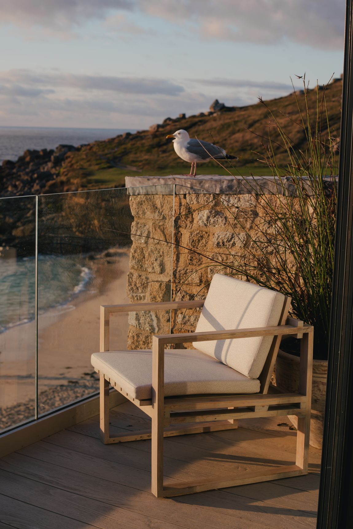 A chair on the penthouse balcony above the beach